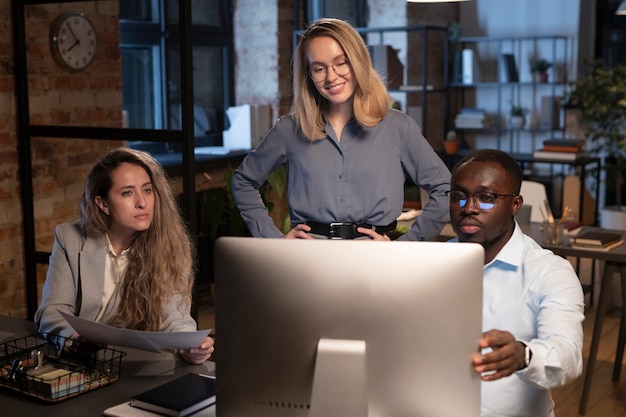 Free photo three coworkers looking the monitor