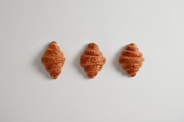 Three delicious croissants with jam for your daily breakfast. Traditional classic french bakery product. Variety of homemade puff pastry. Fresh confectionary. Junk food and calories concept.