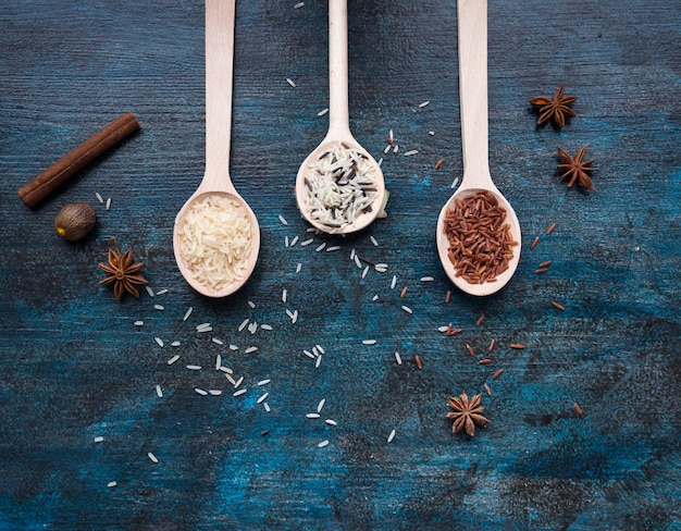 Free photo three different types of rice in spoons on table