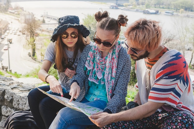 Three friends checking map