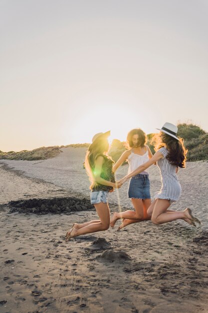 Three friends dancing and jumping