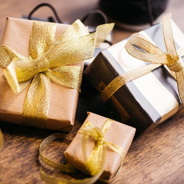 Three gift boxes with ribbons on table