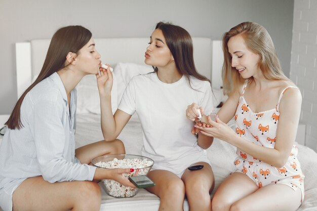 Three girls have pajamas party at home