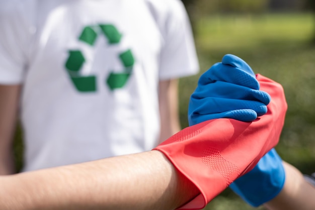 Free photo three men at plastic garbage collecting in a polluted park