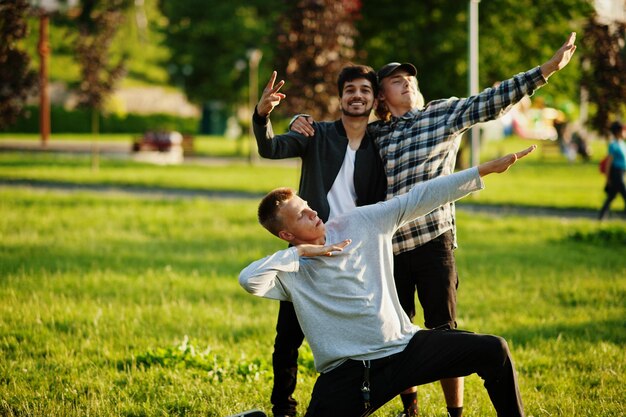 Three multi ethnic guys posed outdoor