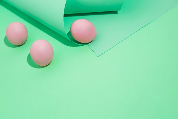 Three pink Easter eggs with rolled paper 