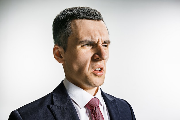 Free photo three-quarter portrait of a businessman with disgust face.