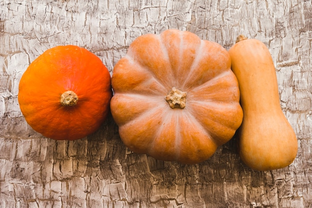 Three ripe squashes on table