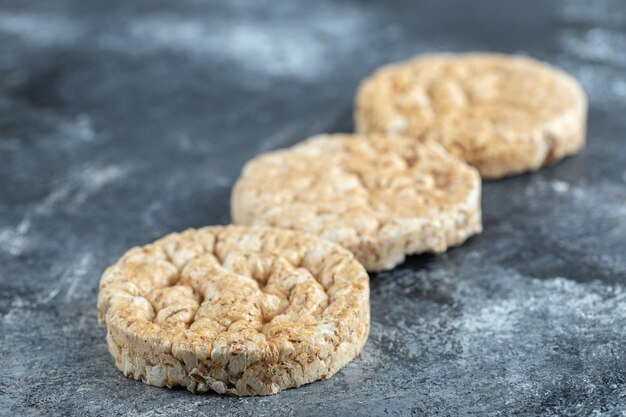 Three round crispbread on marble.