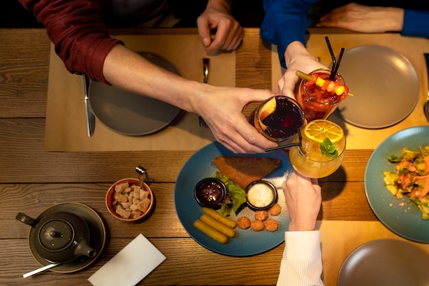 Free Photo three senior friends drinking at a restaurant