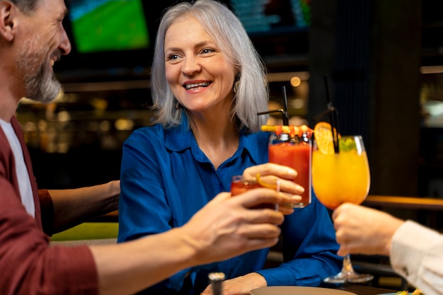 Three senior friends drinking at a restaurant