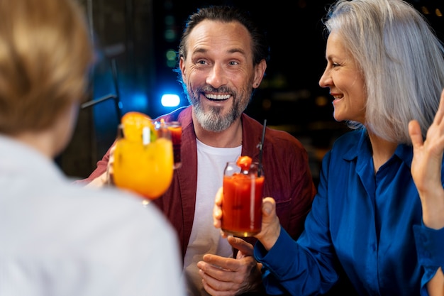 Three senior friends drinking at a restaurant