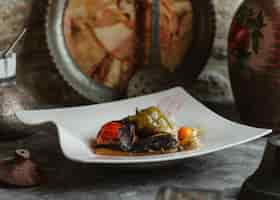 Free photo three sisters domla with eggplant, tomato and green bell pepper.