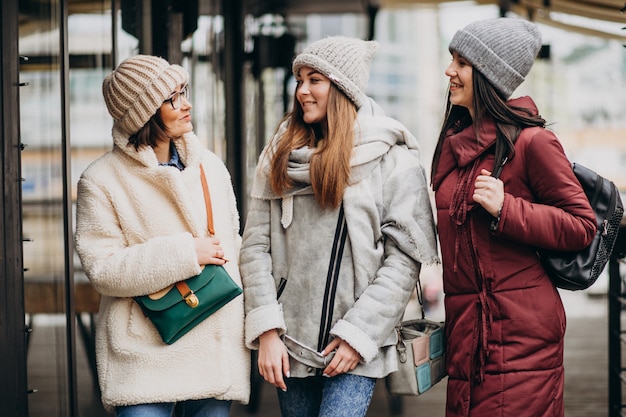 Free photo three students in winter outfit at the street