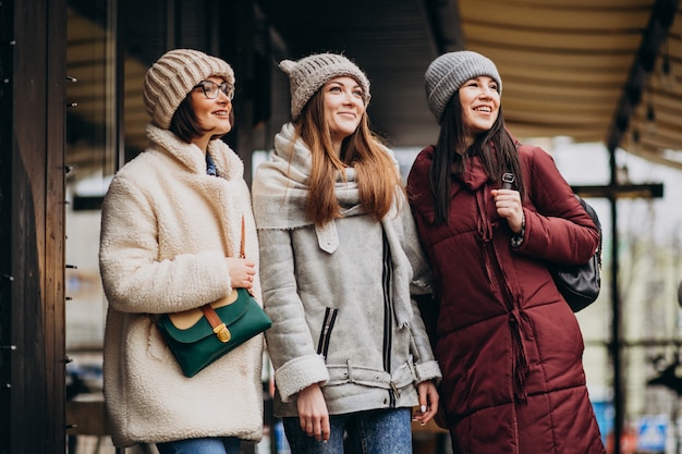 Free Photo three students in winter outfit at the street