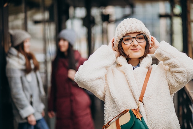 Three students in winter outfit at the street