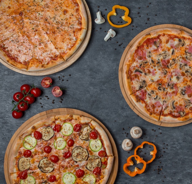 Three types of pizza with mixed ingredients