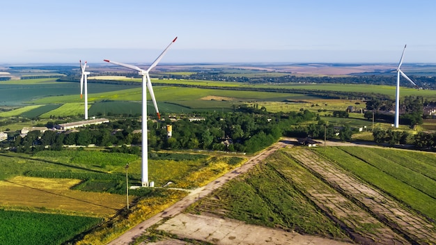 Free Photo three wind turbines located on a field