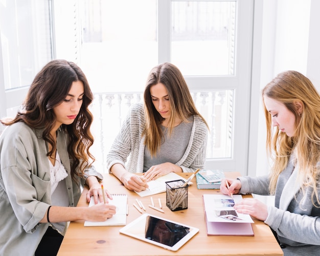 Free photo three women making sketches