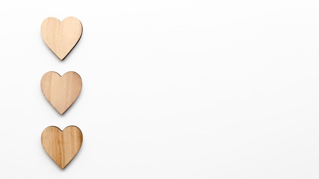 Free photo three wooden hearts on table