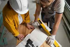 Free photo tiler working on renovation of apartment