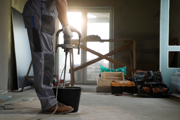 Free photo tiler working on renovation of apartment