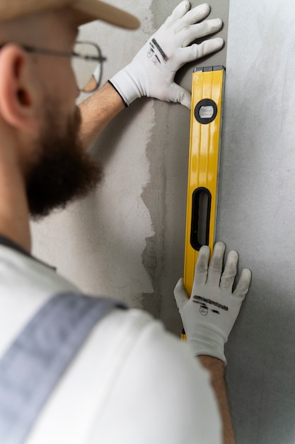 Free Photo tiler working on renovation of apartment