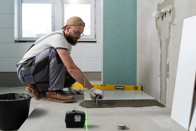 Tiler working on renovation of apartment