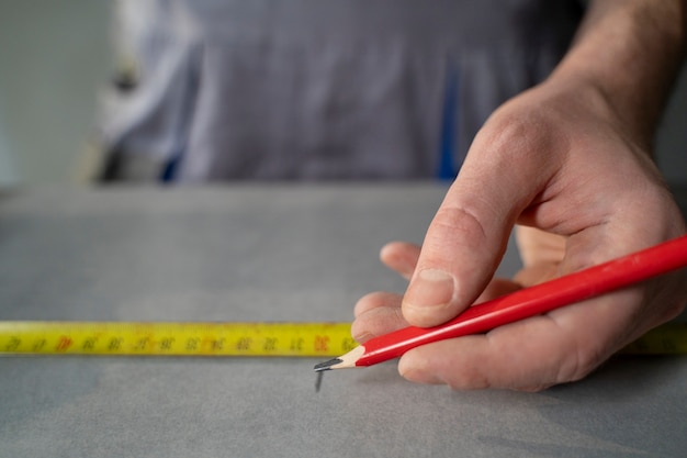 Free photo tiler working on renovation of apartment