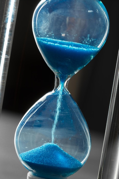 Time is passing blue hourglass close up