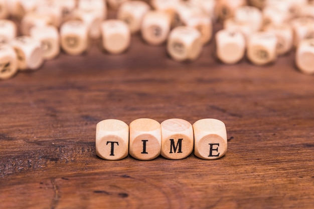 Free photo time word made from wooden cubes