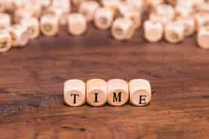 Free photo time word made from wooden cubes