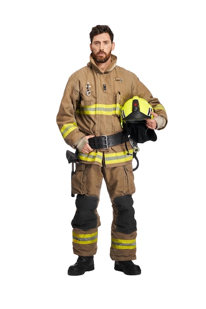 Tired bearded firefighter in uniform holding protective helmet front view of darkhaired male rescuer