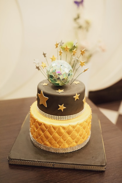 Tired birthday cake with golden glaze