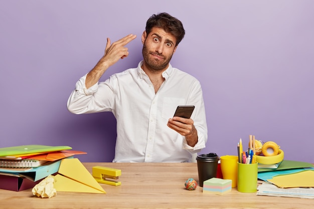 Tired employee sitting at the office desk