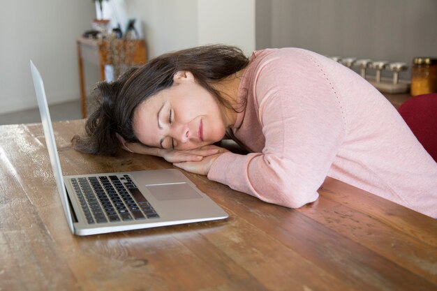 Free photo tired freelance woman sleeping on table