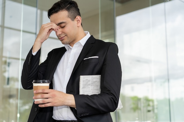 Tired frustrated businessman suffering from headache