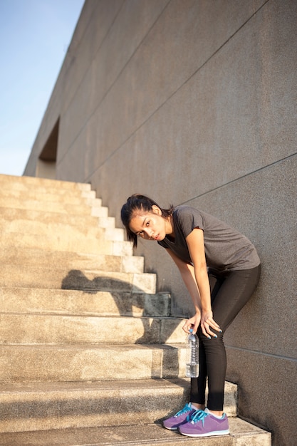 Tired girl resting on the stairs