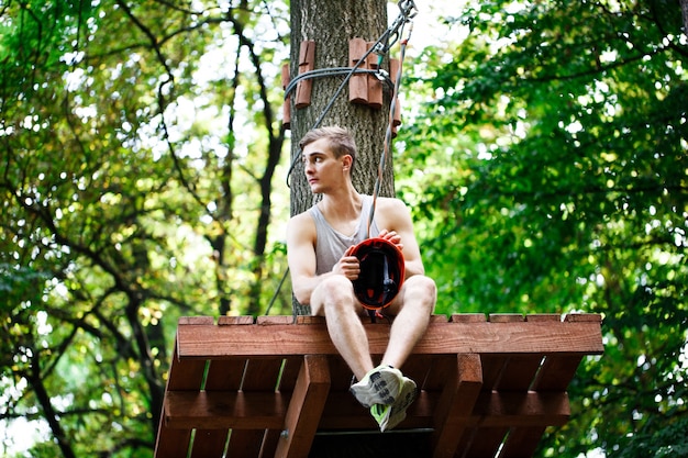 Tired man sits on the tree