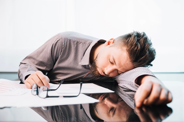 Tired man sleeping in office