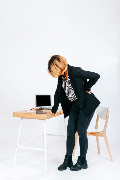 Tired office worker having spine problem