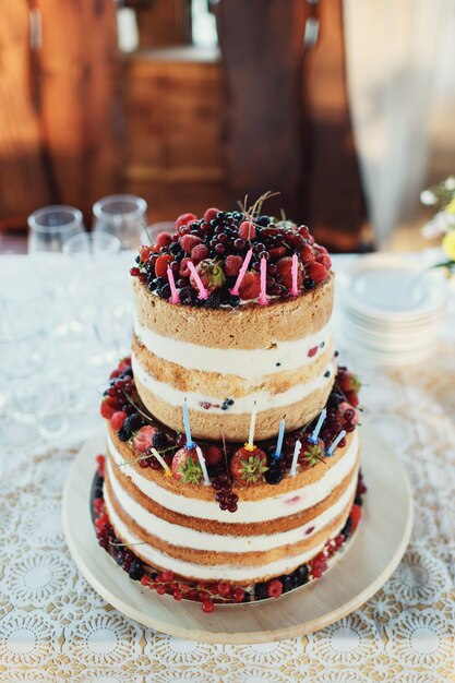 Tired wedding cake made of white cream and berries