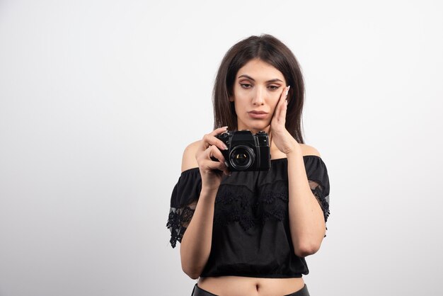 Tired woman posing with camera