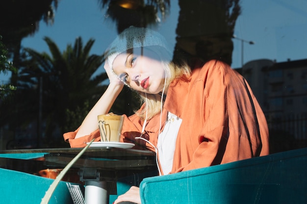 Free photo tired woman sitting in cafe