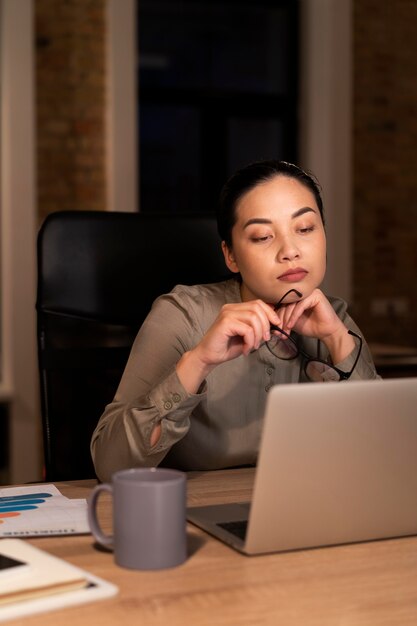 Tired woman working late at the office