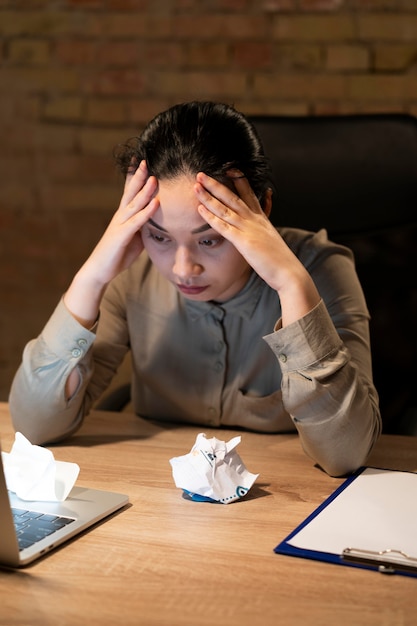 Tired woman working late for a project