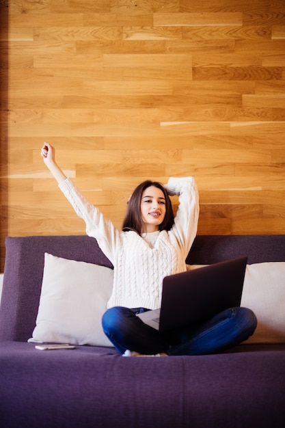 Tired Young attractive woman work at home stretching arms to relax after hard day