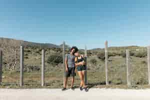 Free photo tired young couple posing after running practice