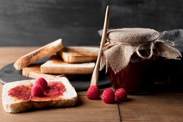 Toast with raspberry jam and jar