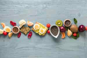 Free photo toasted bread; fresh fruits and ingredients arranged in a row on wooden table